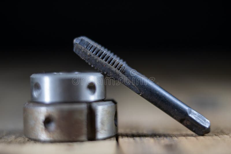 Metalwork tools on the workshop table. Threading dies and taps i royalty free stock photography