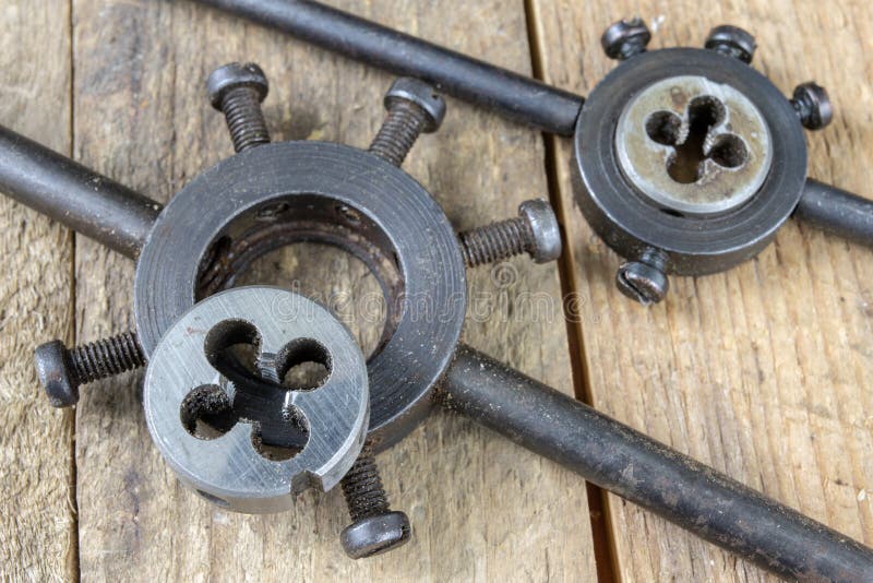 Metalwork tools on the workshop table. Threading dies and taps i stock images