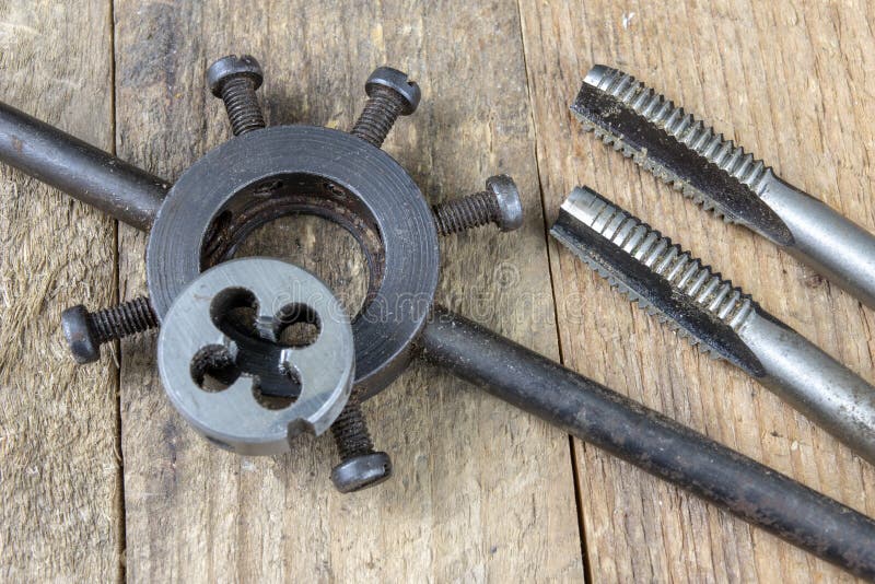 Metalwork tools on the workshop table. Threading dies and taps i royalty free stock image