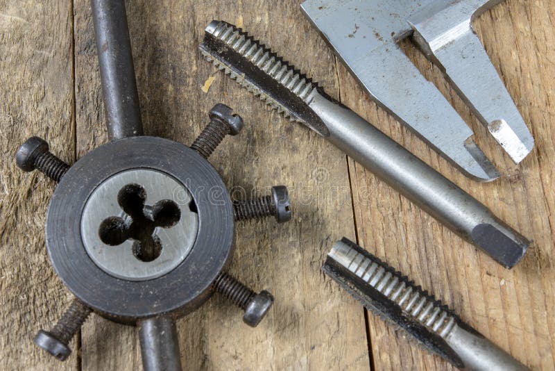 Metalwork tools on the workshop table. Threading dies and taps i stock photography