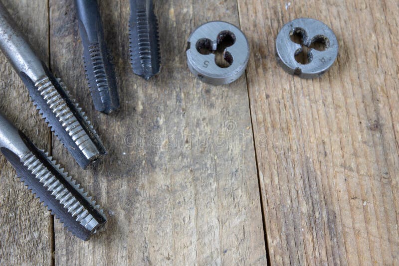 Metalwork tools on the workshop table. Threading dies and taps i stock photo