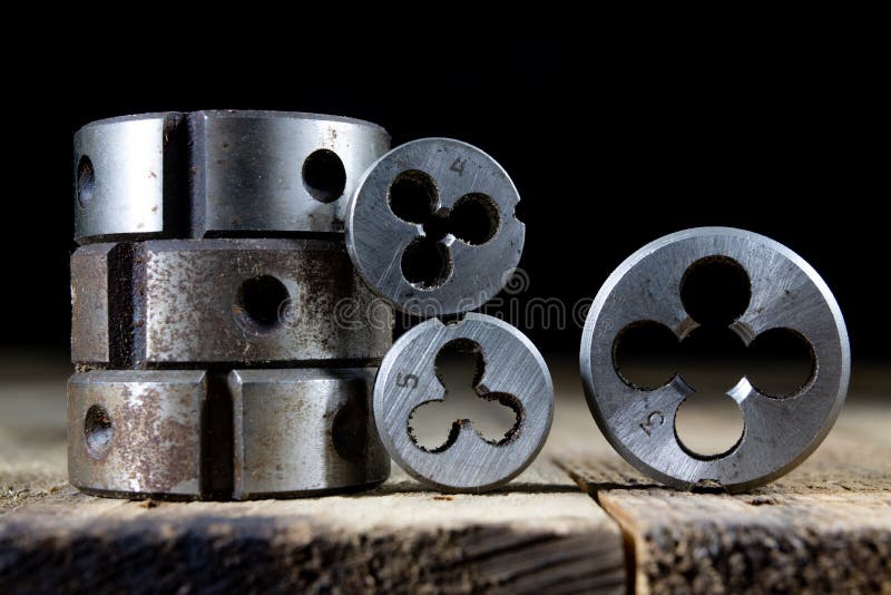Metalwork tools on the workshop table. Threading dies and taps i stock image
