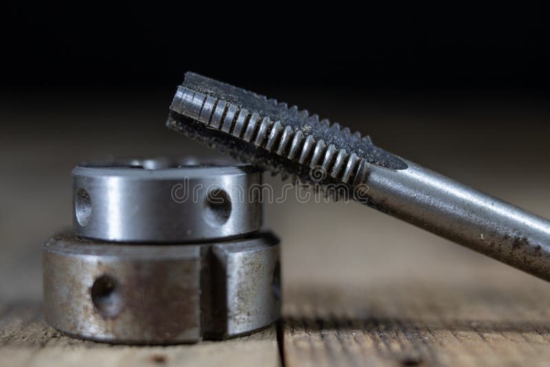 Metalwork tools on the workshop table. Threading dies and taps i stock image