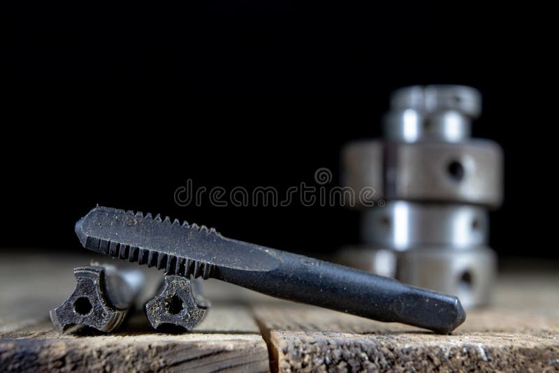 Metalwork tools on the workshop table. Threading dies and taps i stock image