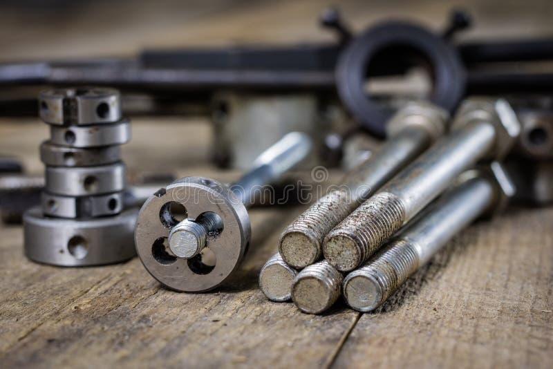 Metalwork tools on the workshop table. Threading dies and taps i royalty free stock image