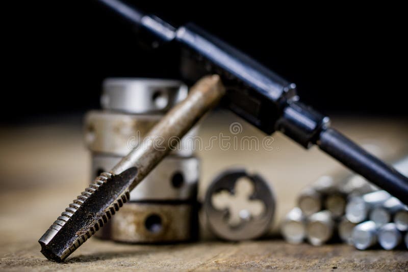 Metalwork tools on the workshop table. Threading dies and taps i royalty free stock photography