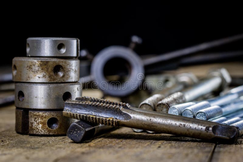 Metalwork tools on the workshop table. Threading dies and taps i royalty free stock image
