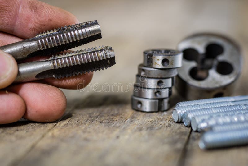 Metalwork tools on the workshop table. Threading dies and taps i royalty free stock photo