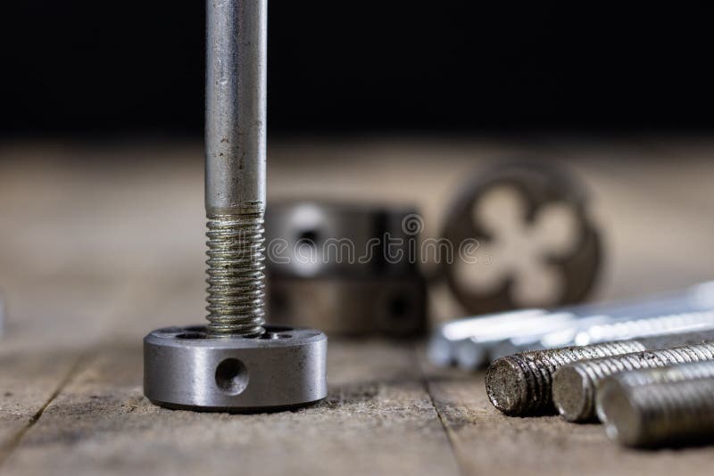 Metalwork tools on the workshop table. Threading dies and taps i stock photos