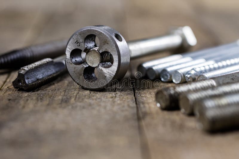 Metalwork tools on the workshop table. Threading dies and taps i royalty free stock photo