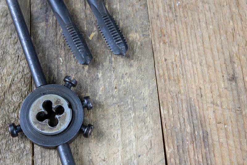 Metalwork tools on the workshop table. Threading dies and taps i royalty free stock photography