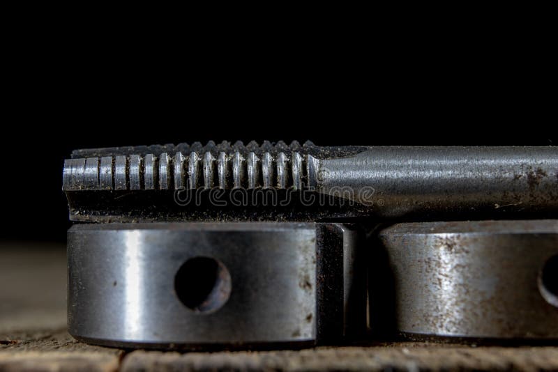 Metalwork tools on the workshop table. Threading dies and taps i stock images
