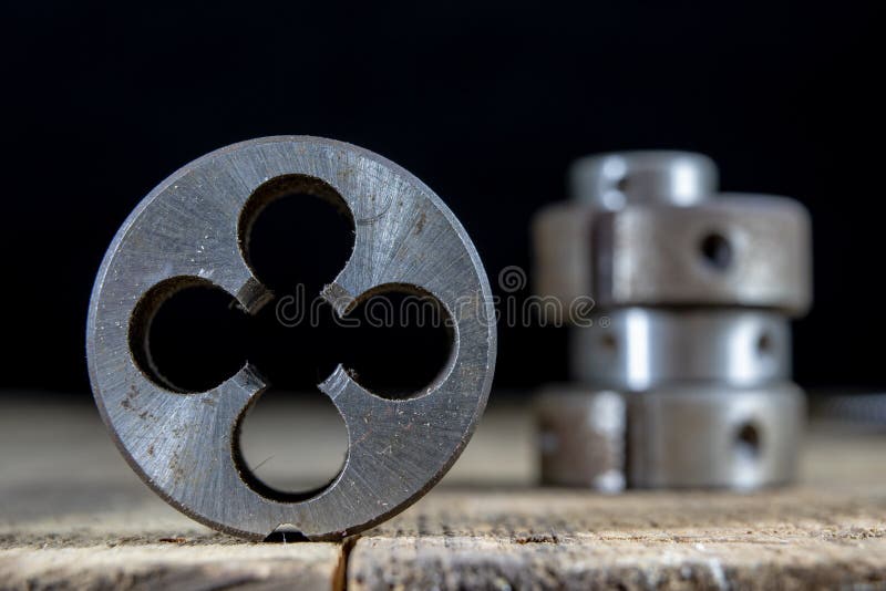 Metalwork tools on the workshop table. Threading dies and taps i royalty free stock images