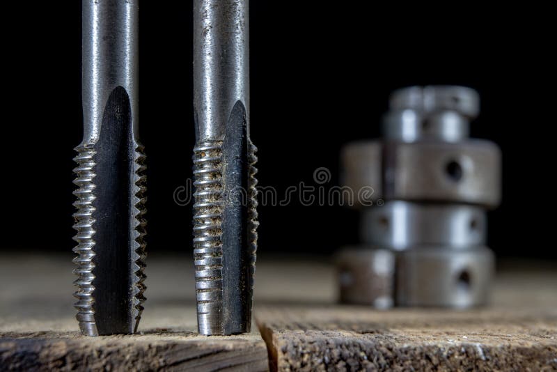 Metalwork tools on the workshop table. Threading dies and taps i stock images
