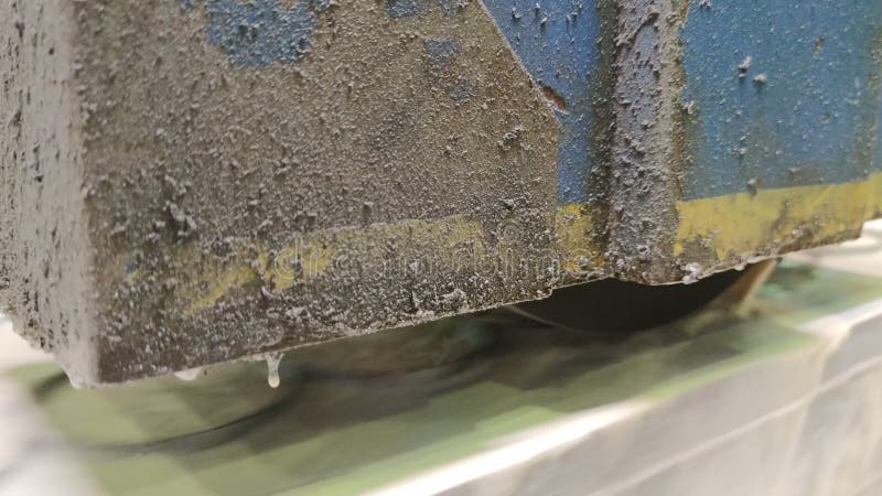 Metalworking industry: a process of wet flat steel abrasion on horizontal surface grinder machine with flying sparks