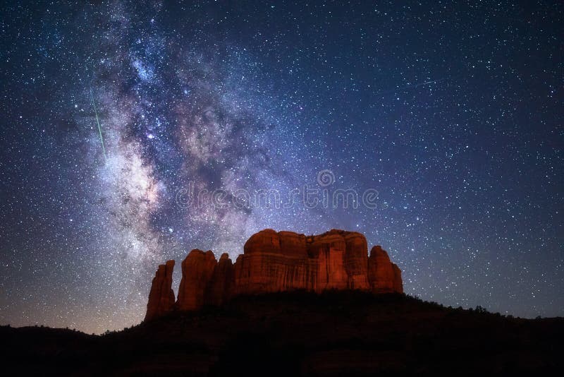 A meteor streaks through the Milky Way above Cathedral Rock in Sedona, Arizona.