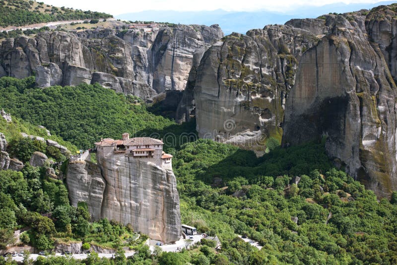 Kalambaka, Greece - May 3, 2016: Mountain, on the tops of steep cliffs which are located one and two-storey houses with tiled roofs. The building strolling tourists. Meteora - one of the largest monasteries in Greece, distinguished, above all, its unique location on the tops of rocks. Monastic center was formed around the X century, and since then there continuously. Meteora is located in the mountains of Thessaly in northern Greece, in the north of the nome Trikala. They are in Khasia mountains near Pinos river in 1-2 km north of the town of Kalambaka, and 21 kilometers north-west of the city of Trikala. Kalambaka, Greece - May 3, 2016: Mountain, on the tops of steep cliffs which are located one and two-storey houses with tiled roofs. The building strolling tourists. Meteora - one of the largest monasteries in Greece, distinguished, above all, its unique location on the tops of rocks. Monastic center was formed around the X century, and since then there continuously. Meteora is located in the mountains of Thessaly in northern Greece, in the north of the nome Trikala. They are in Khasia mountains near Pinos river in 1-2 km north of the town of Kalambaka, and 21 kilometers north-west of the city of Trikala.