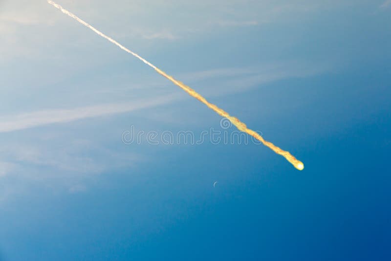 Meteorite falling on blue sky background (collage). Meteorite falling on blue sky background (collage)