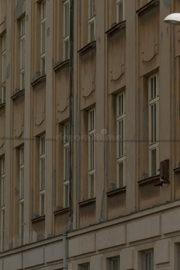 Beige residential elevation with repeating windows and delicate cornices, vertical rhythm and soft shadows. Lintel molding stock images, royalty-free photos and pictures