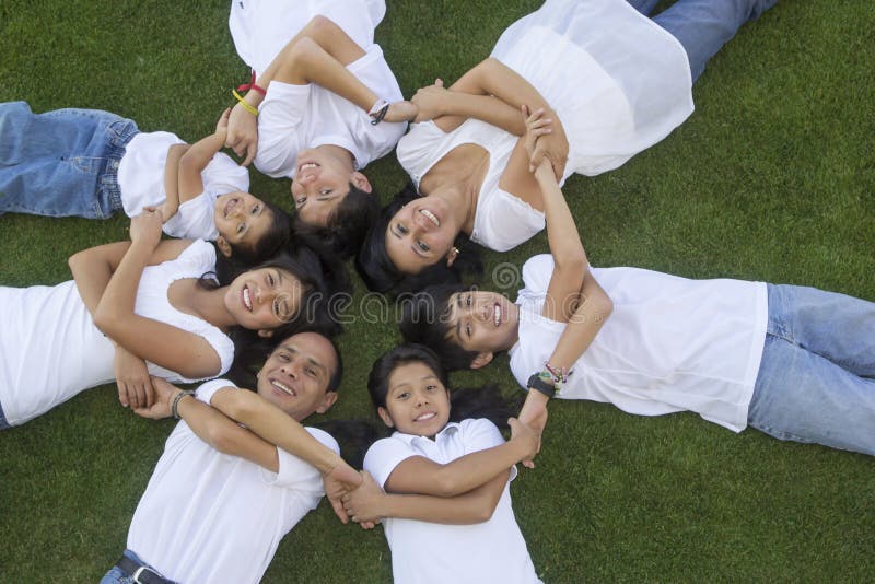 Members of a Mexican family lying on the grass. Members of a Mexican family lying on the grass