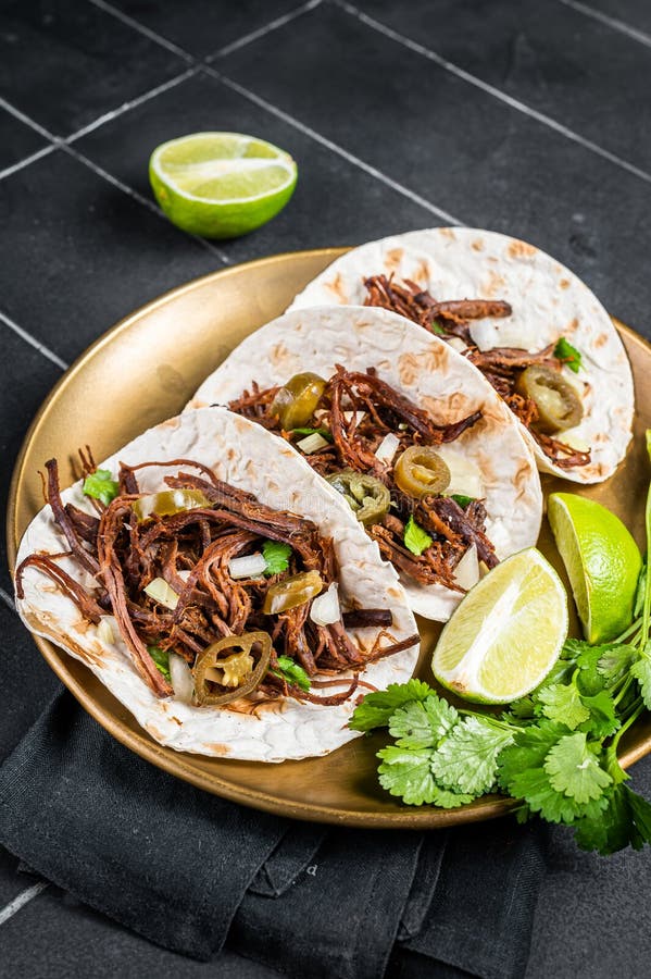 Mexican Beef Barbacoa Tacos with Cilantro and Onion. Black Background