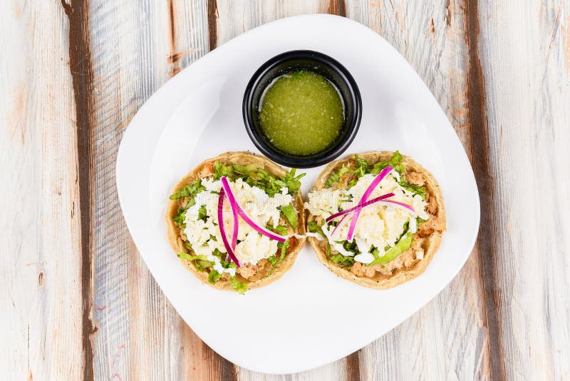 A Mexican dish \ sopes\  made of crab on a restaurant table