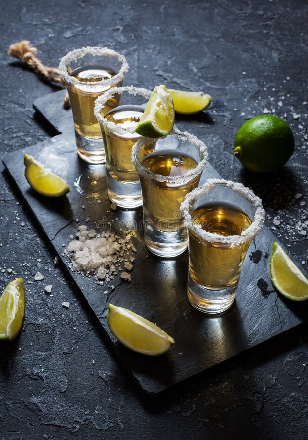 Mexican Gold Tequila with Lime and Salt on Black Stone Background. Top ...