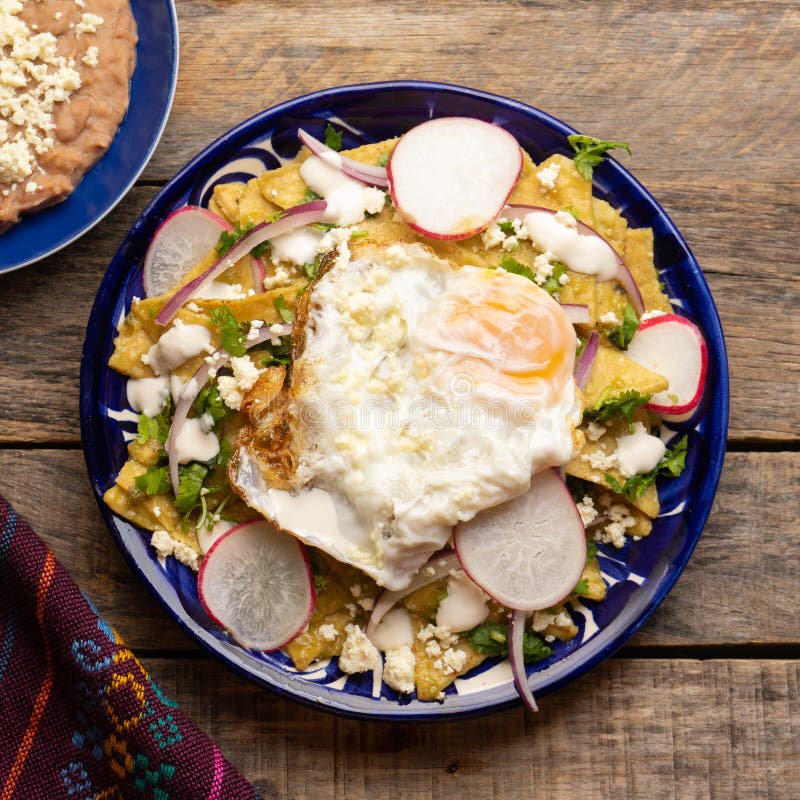 Mexican Green Chilaquiles with Fried Egg and Cheese Stock Photo Image