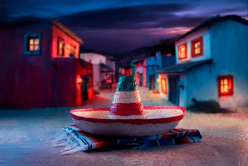 Mexican hat sombrero on a serape in a mexican town at night