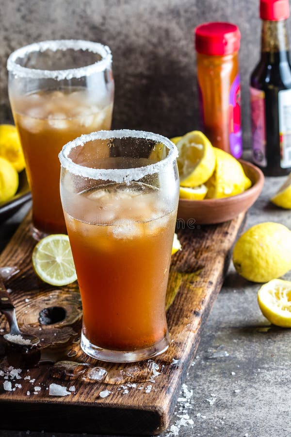 Mexican Michelada. Traditional Latin American mexican spicy refreshing beer drink with lemon juice, salt, ice tabasco