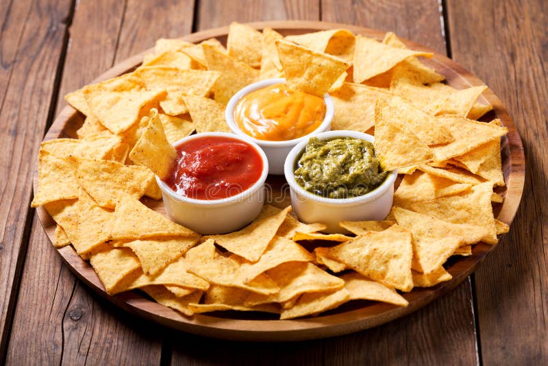 Mexican nachos corn chips with guacamole, salsa and cheese dip royalty free stock image Mexican nachos corn chips with guacamole, salsa and cheese dip royalty free stock image