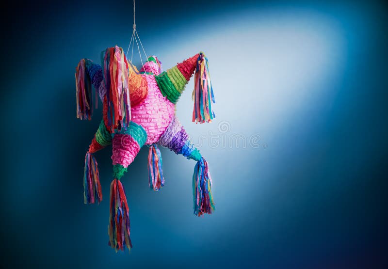 Colorful mexican pinata used in birthdays on a blue background. Colorful mexican pinata used in birthdays on a blue background