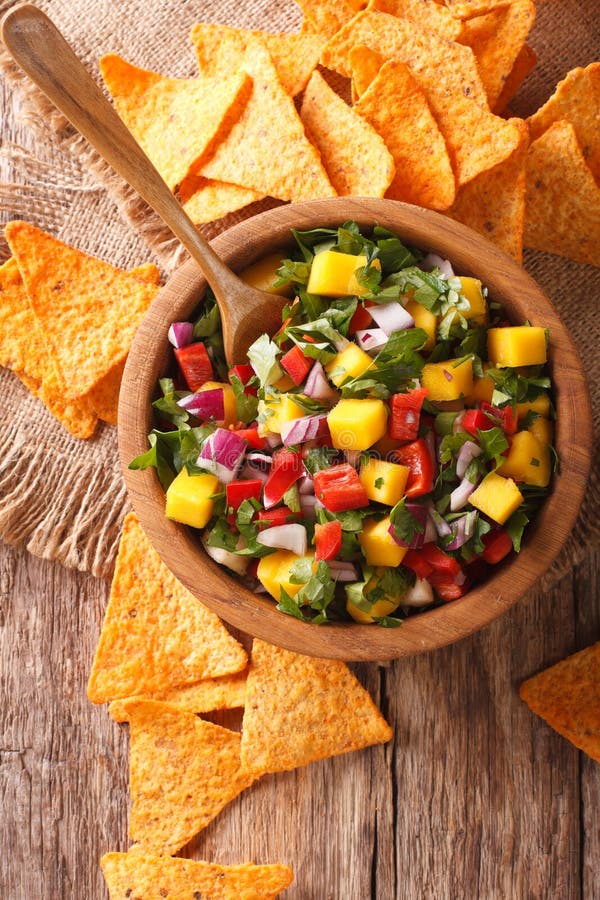 Mexican salsa with mango, peppers, cilantro and onion closeup an