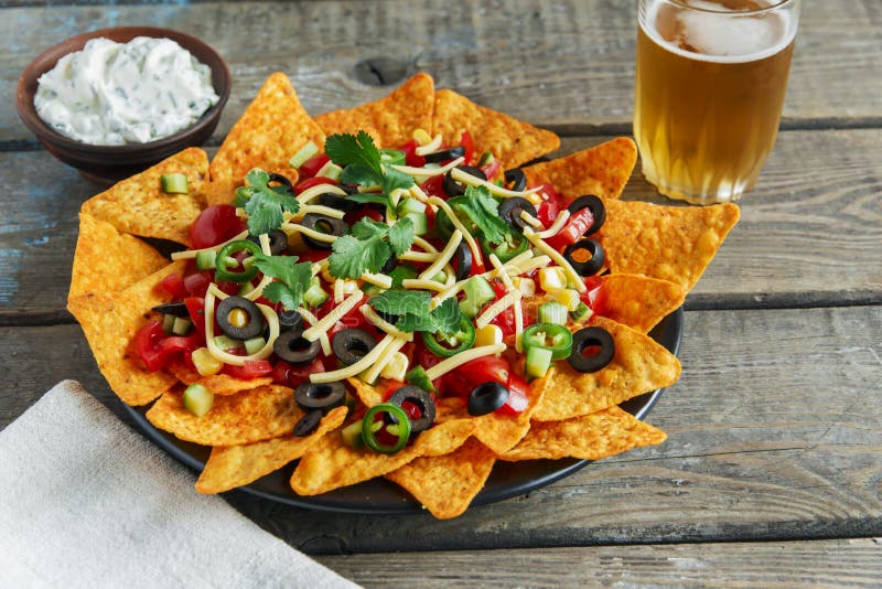 Mexican Tortilla Chips with Cheese Tomato Black Olives Pepper Sauce