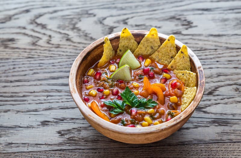 Mexican tortilla soup on the wooden background