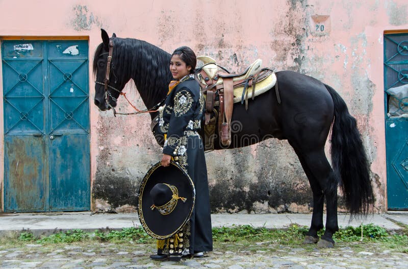 Mexican woman and black horse