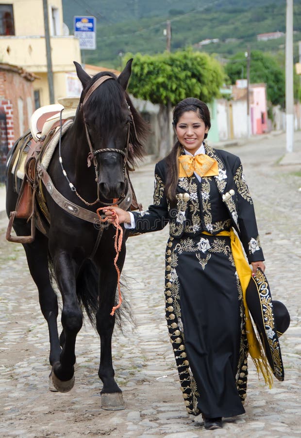 Mexican woman and black horse