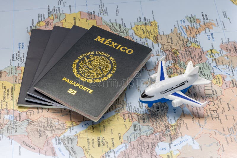 Mexican passport next to an airplane on a world map. Concept: Mexicans traveling abroad