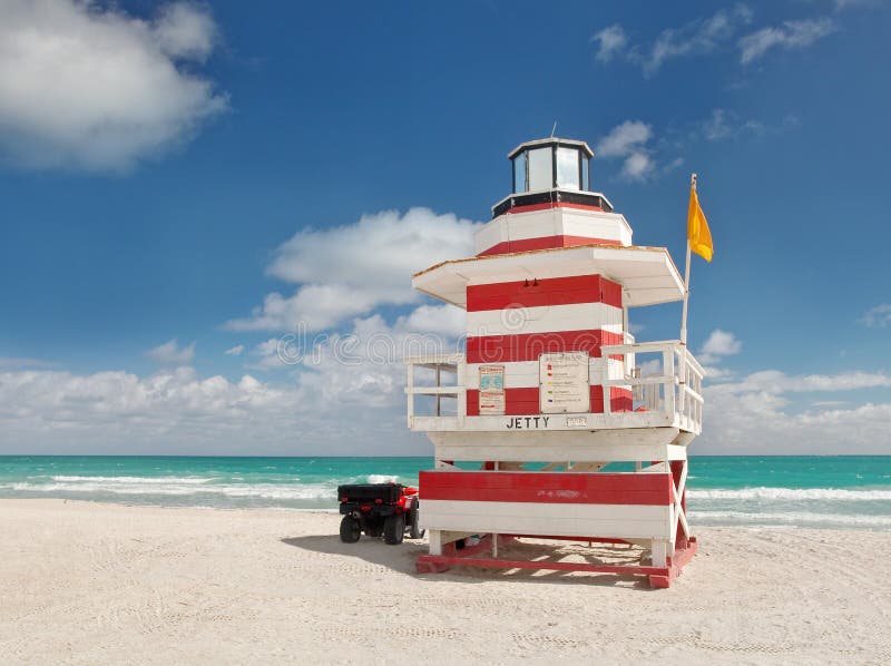 Miami Beach Florida, lifeguard house in a typical colorful Art Deco style on a sunny summer day, with blue cloudy sky and Atlantic Ocean in the background. World famous travel location.