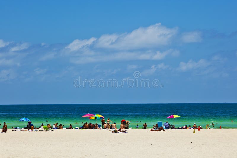 Miami beach with people enjoying the ocean