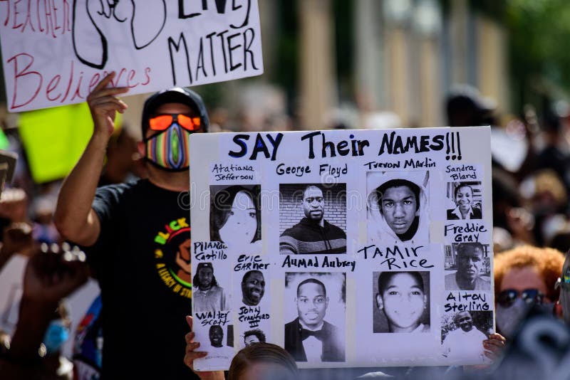 Miami Downtown, FL, USA - MAY 31, 2020: George Floyd, Tamir Rice, Atatiana Jefferson, Trayvon Martin, Ahmed Aubrey, Eric Garner, Sandra Bland, Freddie Gray, Alton Sterling poster. US people protest. Miami Downtown, FL, USA - MAY 31, 2020: George Floyd, Tamir Rice, Atatiana Jefferson, Trayvon Martin, Ahmed Aubrey, Eric Garner, Sandra Bland, Freddie Gray, Alton Sterling poster. US people protest