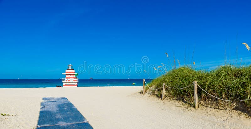 Miami South Beach, lifeguard house in a colorful Art Deco style at sunny summer day with the Caribbean sea in background, world famous travel location in Florida, USA