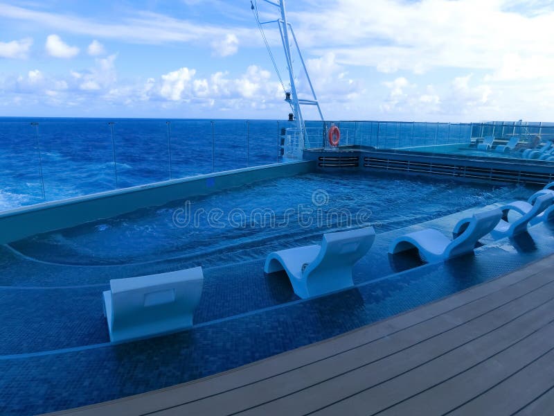 Miami, USA - May 4, 2022: The quiet adult swimming pool area at new cruise ship or new flagship of MSC Seashore, the largest cruise ship built in Italy. Miami, USA - May 4, 2022: The quiet adult swimming pool area at new cruise ship or new flagship of MSC Seashore, the largest cruise ship built in Italy.