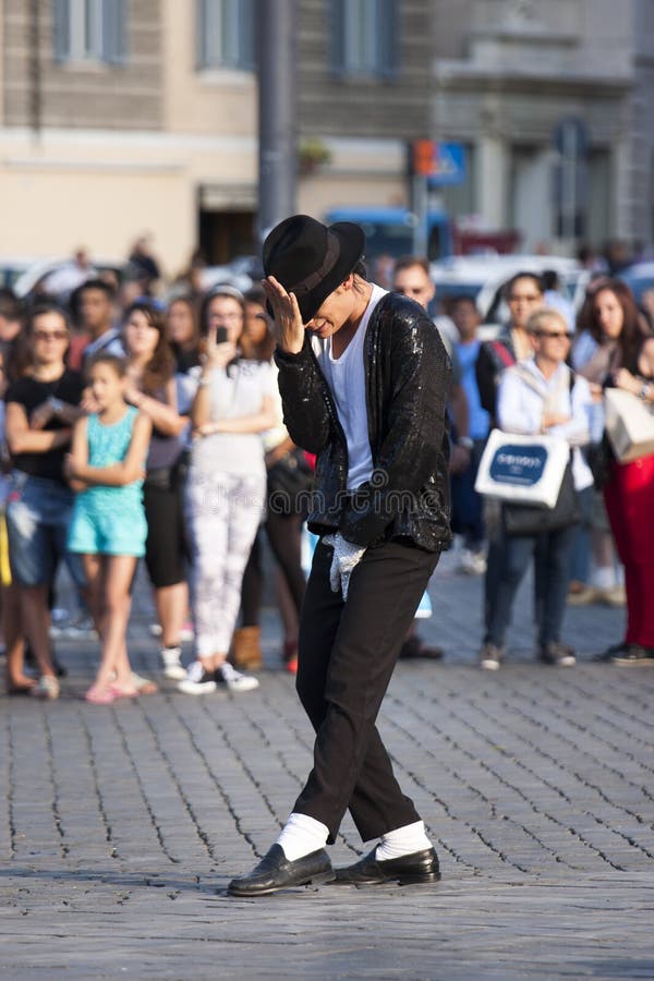 A Michael Jackson impersonator is performing in a square. Her clothes are those worn in Billie Jean by the famous singer who died. Location: Piazza del Popolo (Rome, Italy). A Michael Jackson impersonator is performing in a square. Her clothes are those worn in Billie Jean by the famous singer who died. Location: Piazza del Popolo (Rome, Italy).