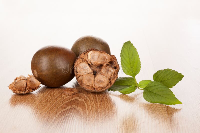 Luo Han Guo aka Monk fruit natural remedy on wooden background. Powerful healthy sweetener. Luo Han Guo aka Monk fruit natural remedy on wooden background. Powerful healthy sweetener.