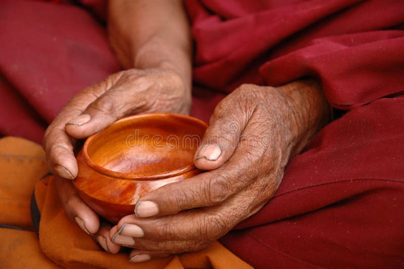 Old hands of a monk holding a tea bowl. Old hands of a monk holding a tea bowl