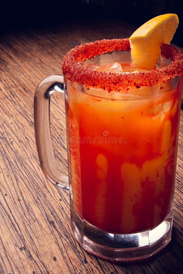 Michelada Beer with Tomato Juice. Clamato with Beer on Wooden Table ...