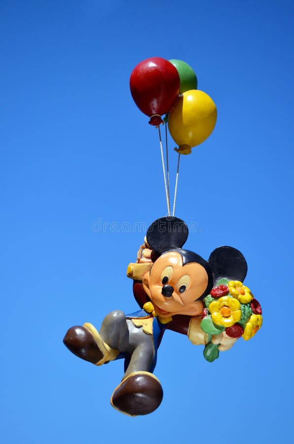 Mickey Mouse Disney figure part of a huge private collection of big figs and original Disney store display figures. Mickey Mouse is floating with balloons with a blue sky background