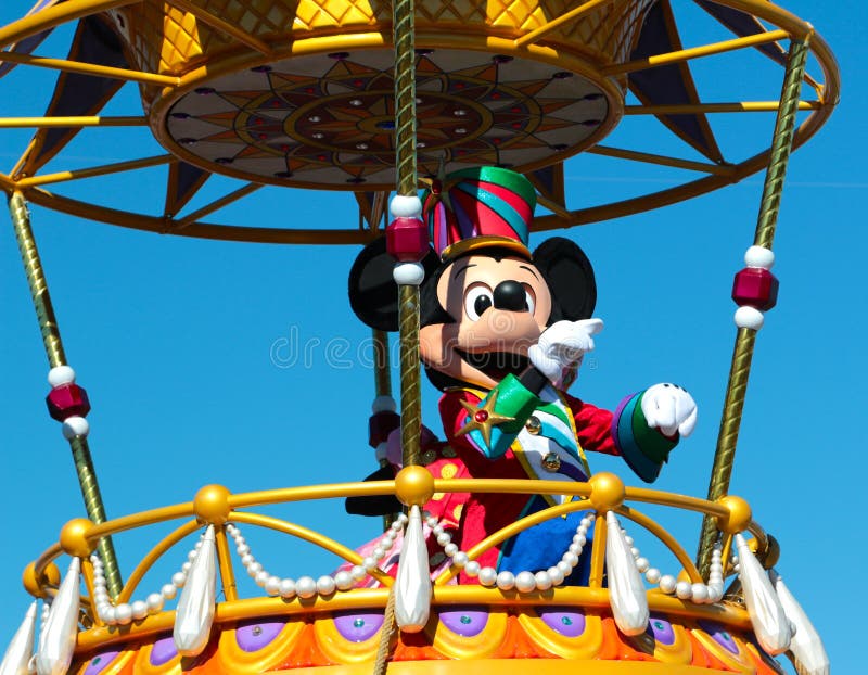 A smiling and waving Mickey Mouse at Disney World in Orlando Florida. A smiling and waving Mickey Mouse at Disney World in Orlando Florida.