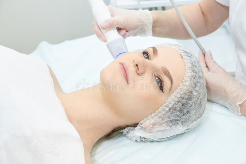 Microcurrent technology equipment. Beautiful young girl. stock photography Microcurrent technology equipment. Beautiful young girl. stock photography